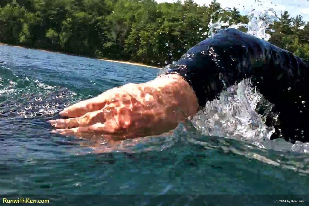 Dramatic, up-close sports photography of Wheelworks Multisport Triathlon Team members open water swimming at Walden Pond in Concord, MA. Photo by Ken Skier, the Swimming Photographer (RunwithKen.com)