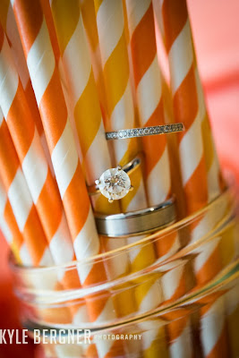Close up of the wedding rings on colorful straws