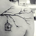 Tree branch and cage tattoo