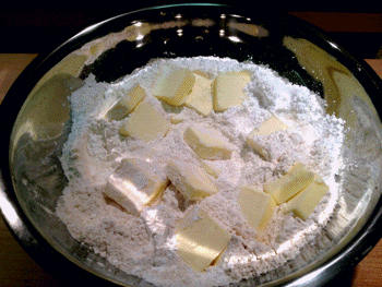 Bowl of butter slices and flour for pie crust Bowl of butter slices and flour for pie crust