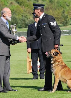 SPUD with Paul who is shaking the hand of Prince Michaem of Kent. SPUD is licking his chops!