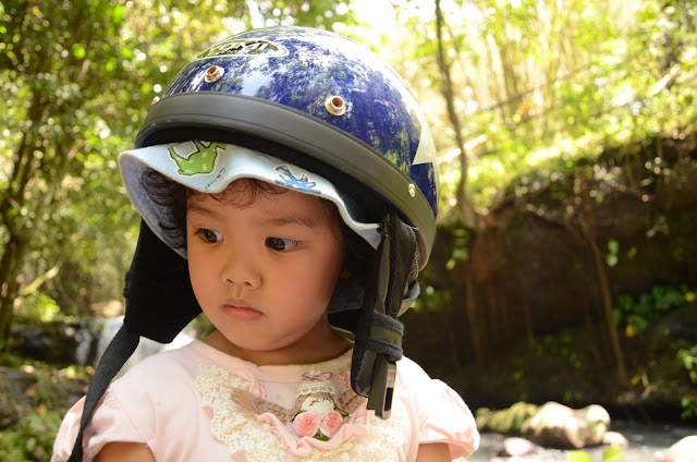 Kecil with helmet at the waterfall