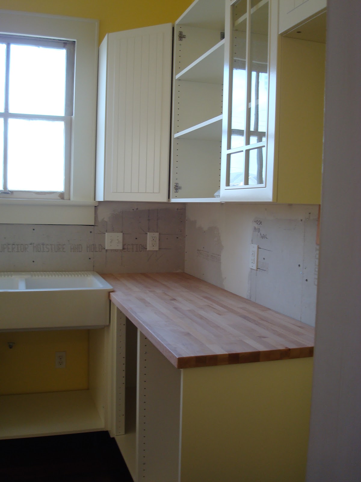 Installing ikea kitchen cabinets but we think a darker color would look better with the white cabinets