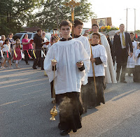 altar servers in the procession for our lady's feast day