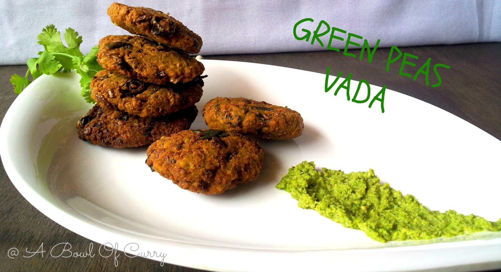 A Bowl Of Curry Green Peas Vada