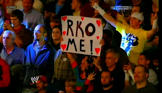 A fan holds an RKO me signboard