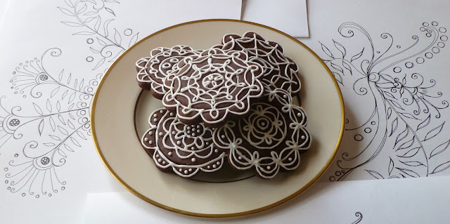 originial, fanciful ink drawing and a plate of decorated dark-chocolate tea biscuits