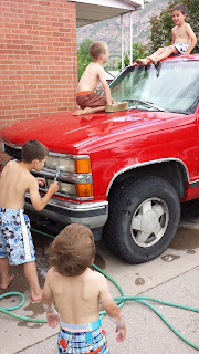 Boys Washing the Car Cleaning the Bugs Off