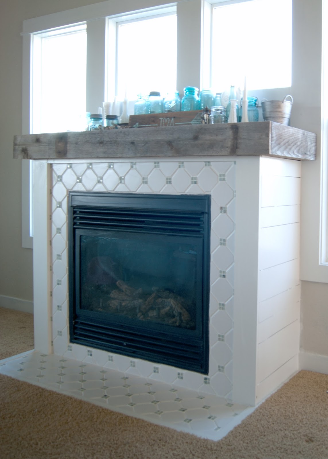 Fireplace Makeover - DIY Fireplace makeover using reclaimed and salvaged materials - octagon & dot tile, reclaimed wood,  white paint, planking - all for under $60! Before and After and links to all the steps!