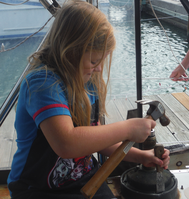 Chasity helping to chisel the corrosion out from between the aluminum base and bronze winch Chasity helping to chisel the corrosion out from between the aluminum base and bronze winch
