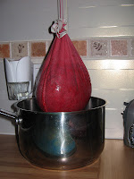 straining raspberries in a jelly bag