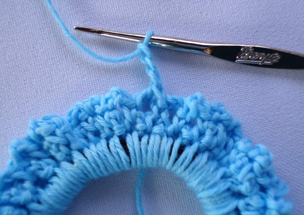 Round 3: Single crochet into the first chain-3 space. Chain 3.