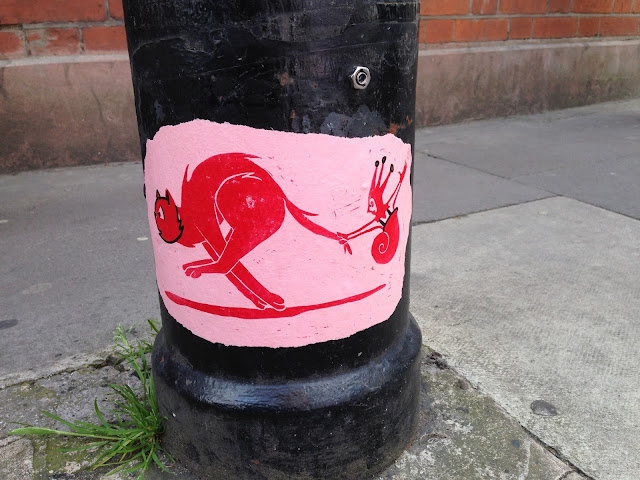 Sneaky street art lamp post