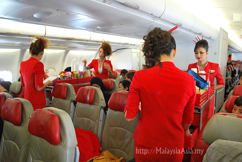 Air Asia X Flight Attendants serving in flight meals on the Osaka Air Asia X Flight Attendants serving in flight meals on the Osaka
