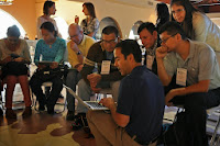 Photo of Gerardo Capiel, Benetech's VP of Engineering, speaking to participants at a conference and showing them a presentation on a laptop.