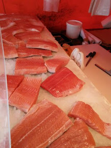 "Fish Stall" at Market Square. :- chunk of salted raw salmon being processed and cured in Helsinki