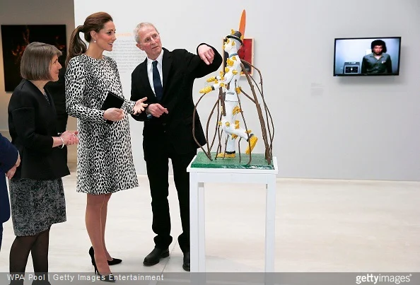 Catherine, Duchess of Cambridge talks to artist John Davies about his sculpture 'Scarecrow' during a visit to Turner Contemporary Gallery 