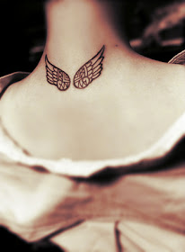 Mayan style of angel wing tattoo behind the neck