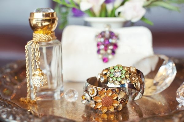 perfume bottle and sparking rings on a dressing table