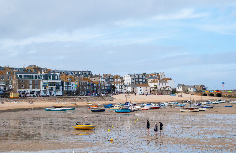 Boats and houses in st ives St. Ives, boats and houses with people strolling along the beach west cornwall, england, UK