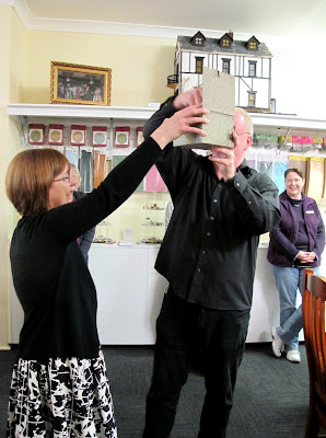 The owners of Fairy Meadow Miniatures shop drawing the raffle.