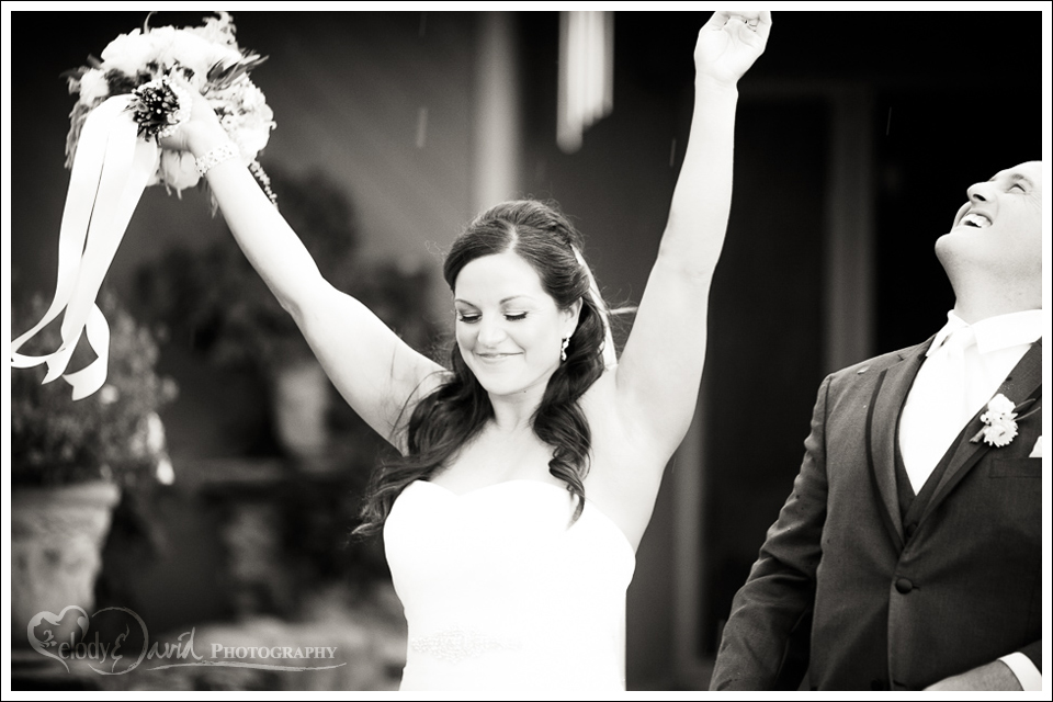 Let it rain Bride and groom walking out in the rain