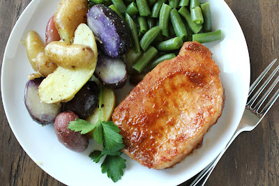 purple, red, yellow fingerling potatoes, pork chop, green beans