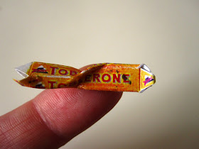 Miniature vintage empty and crumpled Toblerone chocolate package.