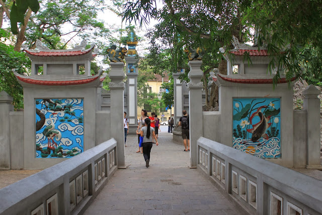 Turning my back to view the rear of the main entrance of Three-Passage Gate (Tam Quan) of Ngoc Son Temple at Hoan Kiem Lake in Hanoi, Vietnam Turning my back to view the rear of the main entrance of Three-Passage Gate (Tam Quan) of Ngoc Son Temple at Hoan Kiem Lake in Hanoi, Vietnam