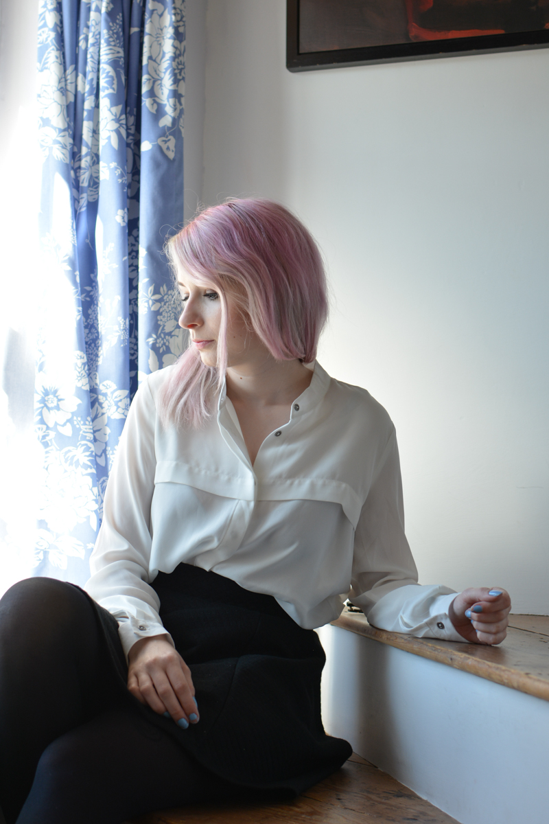 girl in window seat with pink hair