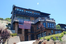 stayathomeista shingle house with giant american flag