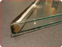 Cross section of a typical double thermal pane window. Note that the space is a "box spacer" and is filled with beads of desiccant. Seattle window glass replacement