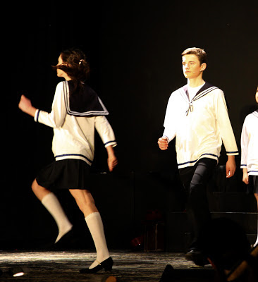 Two of the Von Trapp children marching onto stage