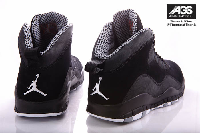 Black holds steady at the midsole, which sits atop a white and grey rubber outsole etched with MJ\u0027s career achievements.