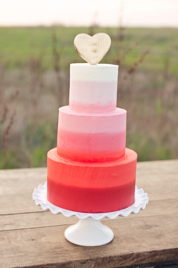 A pretty reddish pink ombre wedding cake featured in Style Me Pretty A pretty reddish pink ombre wedding cake featured in Style Me Pretty