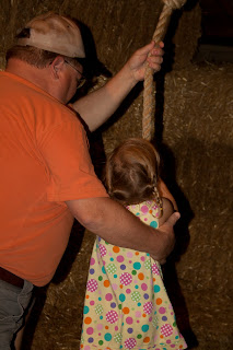 Grandpa helps Sierra with the rope swing at Purina Farms