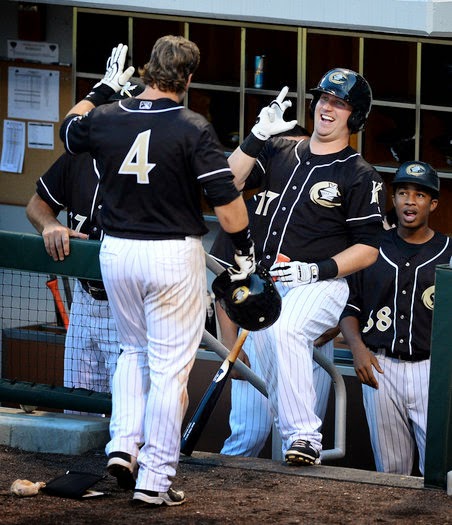 Charlotte Knights Andy Wilkins (17) smiles and jokes with catcher Josh Phegley (4) following Phegley's home run vs the Scranton/Wilkes Barre Railriders at BB&T BallPark in Charlotte, NC on Thursday, July 17, 2014. Wilkins would hit two home runs during the game. (Jeff Siner)