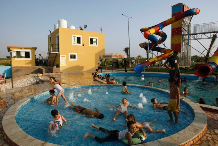 Palestinian Children play in water in Gaza Strip