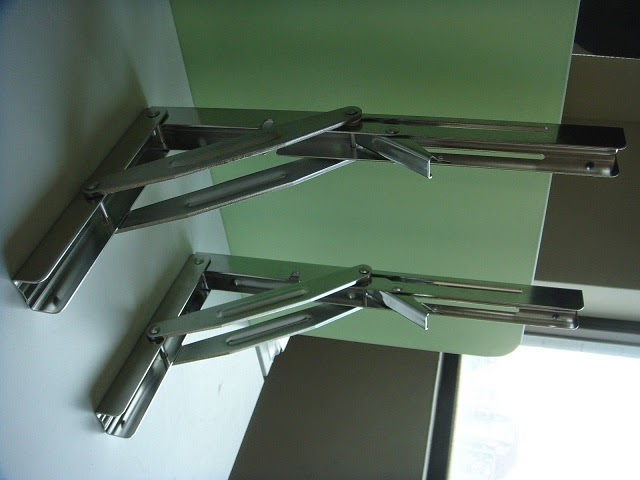 River Shed Marine Folding Table Brackets In The Upright Position These Brackets Lock Place To Support A Tabletop Load Up 300 Pounds Folded Down Table Hangs On Wall Out Of Way