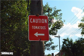 confusing signpost - caution tomatoes