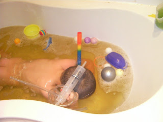 kid in bath with snorkel