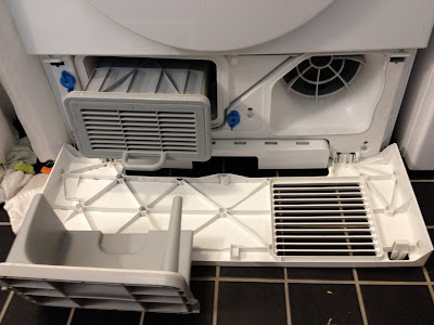 filter visible after opening front panel at bottom of dryer filter for dryer in apartment in Vastra Hamnen