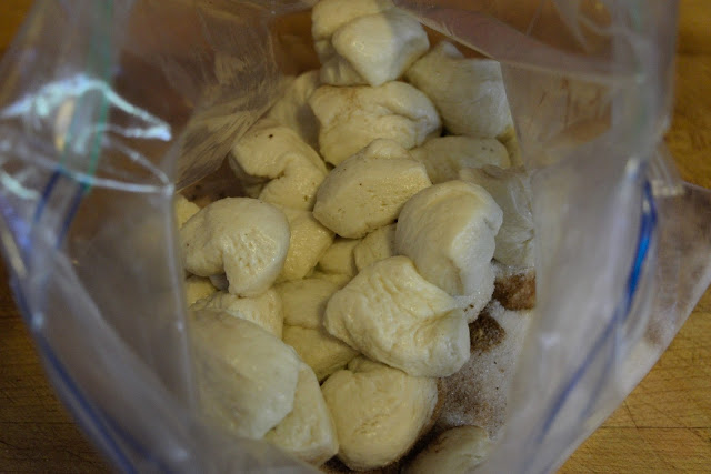 The balls  of dough being added to the resealable bag. 