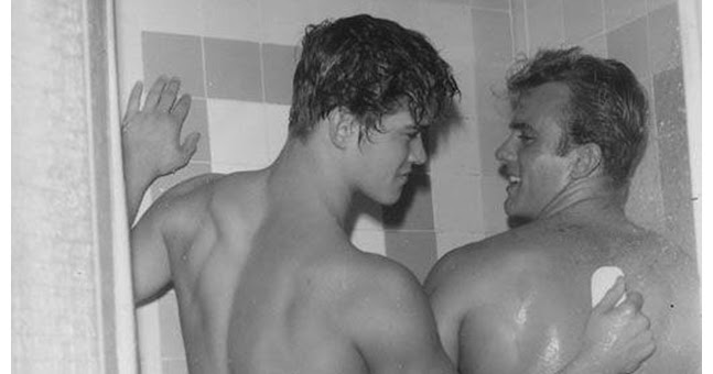 Nude lads comparing in the shower
