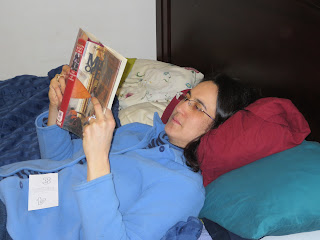 Woman reading a book in bed