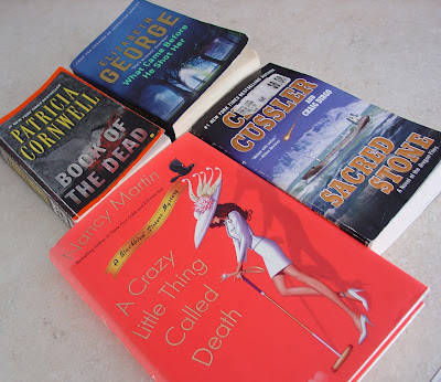 4 books that Vicky has recently read: A Crazy Little Thing Called Death by Nancy Martin, Sacred Stone by Clive Cussler, Book of the Dead by Patricia Cornwell, and What Came Before He Shot Her by Elizabeth George
