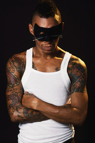 Black man with a mask having sleeve dragon tattoo to chest An Asian girl