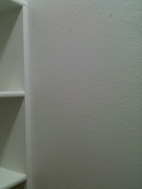To repair a wall like this, you first use spackle to fill in the nail holes,