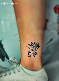 concise and elegant lotus flower tattoo