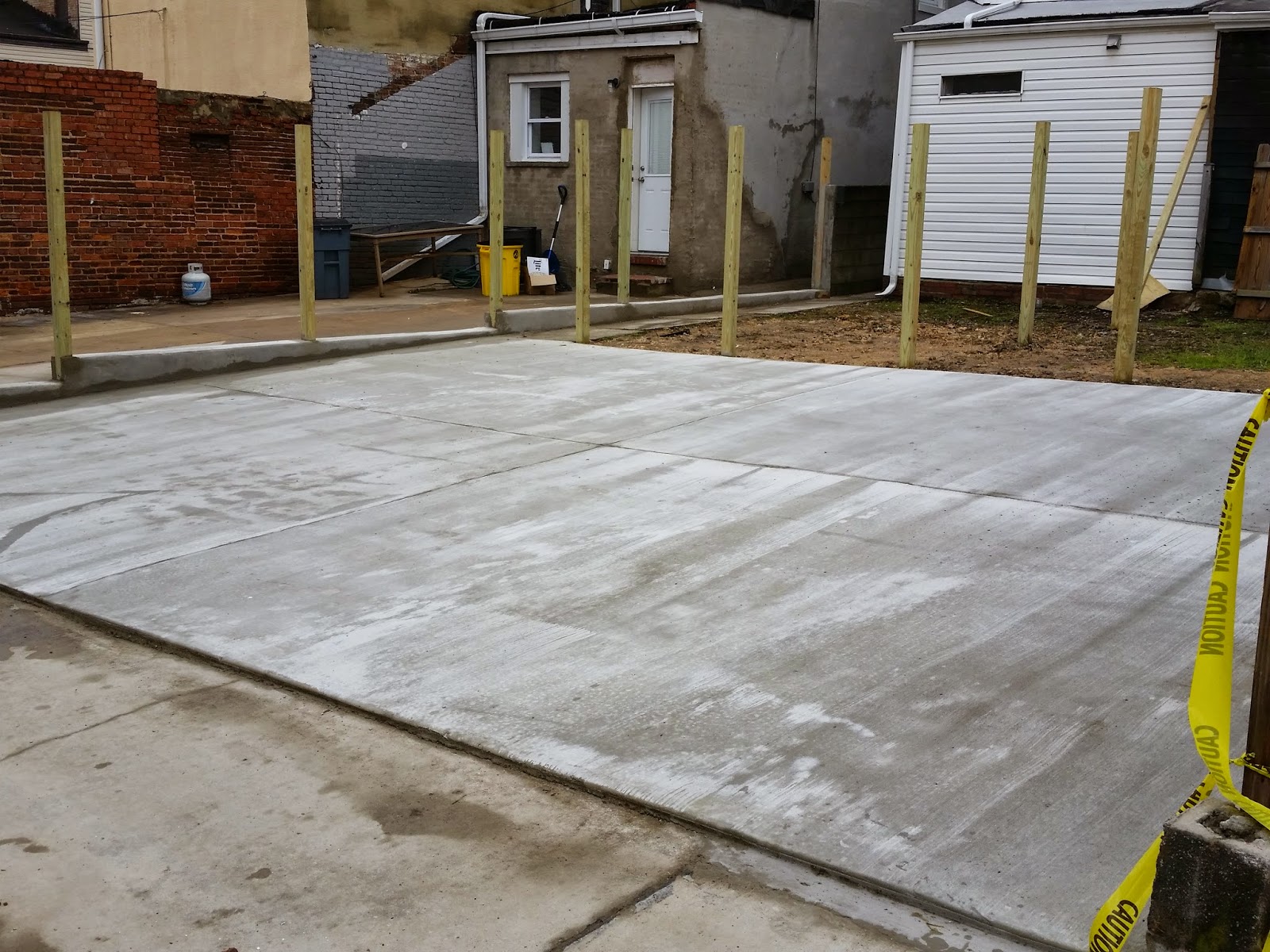 Custom Stoneworks & Design Inc. Concrete parking pad driveway in
